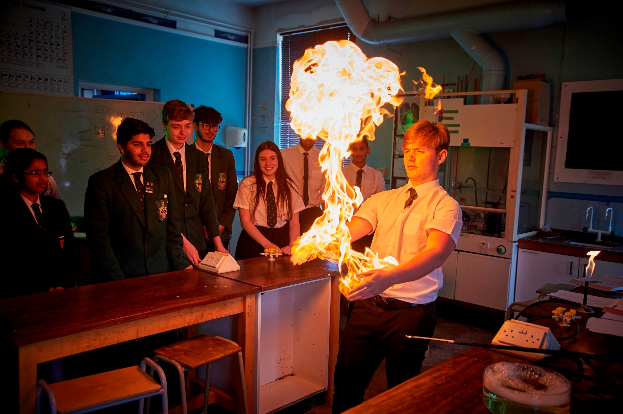 Students watching a science experiment involving flames